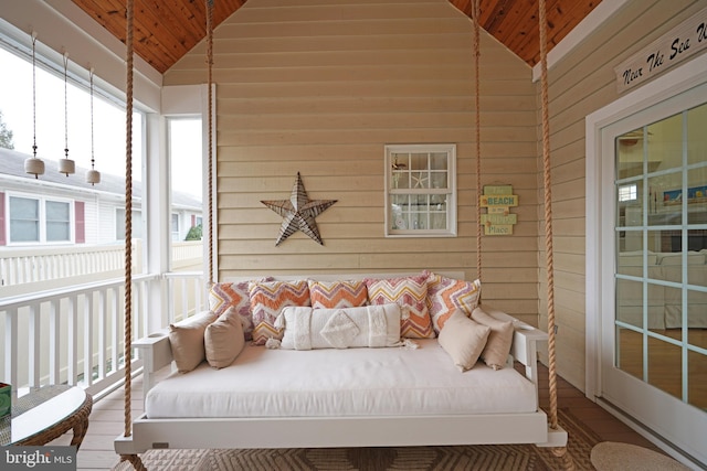 sunroom / solarium featuring vaulted ceiling and wooden ceiling