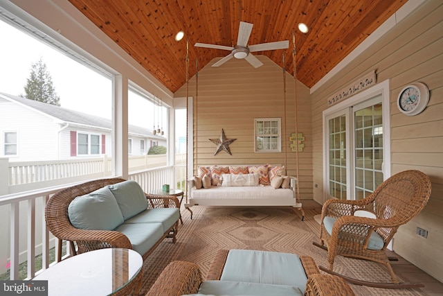 sunroom featuring lofted ceiling and wood ceiling