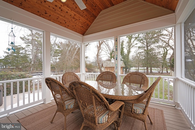 sunroom featuring vaulted ceiling, a healthy amount of sunlight, and wooden ceiling