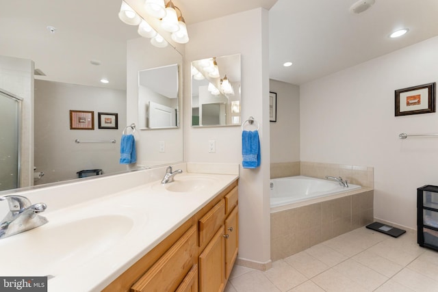 bathroom featuring vanity, tiled bath, and tile patterned floors