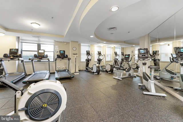 gym with a tray ceiling