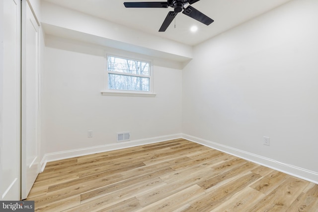 empty room with ceiling fan and light hardwood / wood-style floors