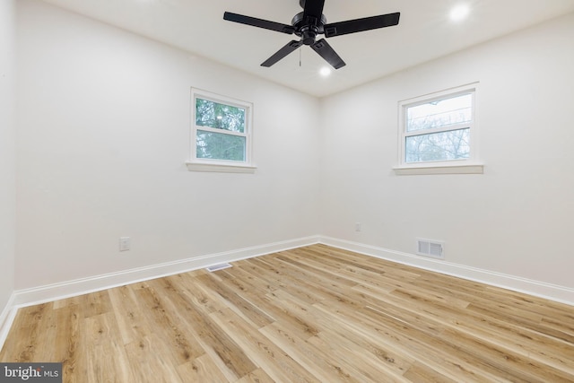 unfurnished room with ceiling fan, a healthy amount of sunlight, and light hardwood / wood-style flooring