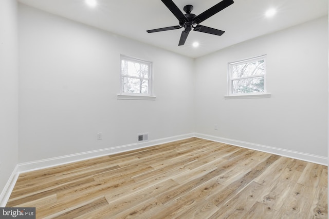 empty room with light wood-type flooring, ceiling fan, and plenty of natural light