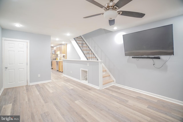 unfurnished living room featuring ceiling fan and light hardwood / wood-style flooring