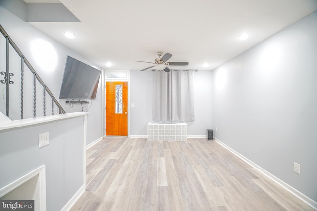 empty room featuring ceiling fan and light hardwood / wood-style floors