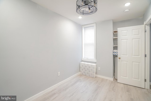 unfurnished bedroom featuring a closet and light wood-type flooring