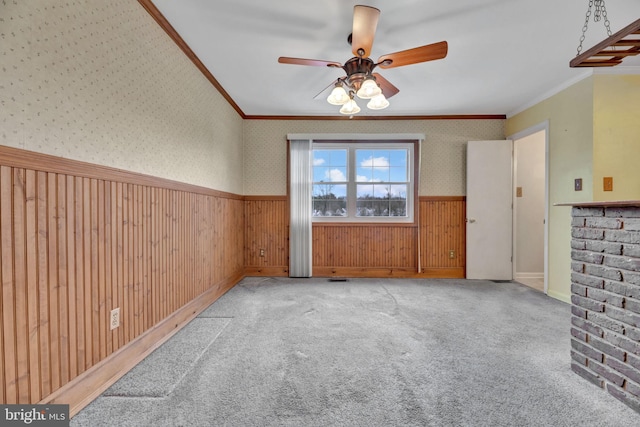 interior space with crown molding, light colored carpet, and ceiling fan