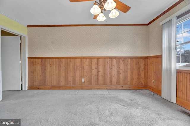 spare room with ornamental molding, light carpet, and ceiling fan