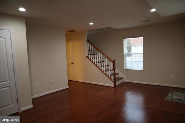 unfurnished room featuring dark wood-type flooring