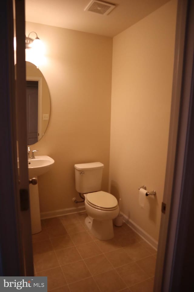 bathroom with tile patterned flooring and toilet