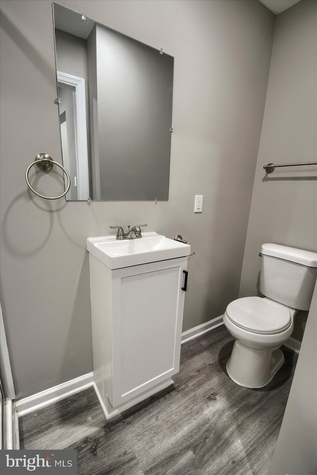 bathroom with vanity, hardwood / wood-style flooring, and toilet