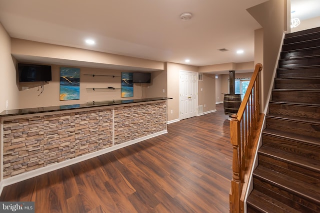 bar with wood-type flooring