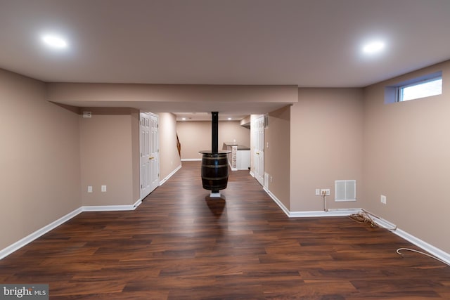 basement with dark hardwood / wood-style flooring