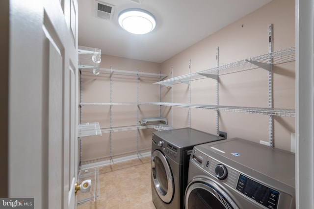 clothes washing area featuring separate washer and dryer