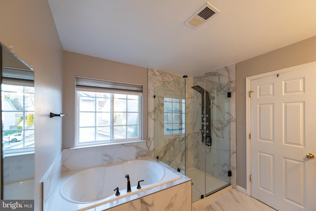 bathroom featuring shower with separate bathtub and a healthy amount of sunlight