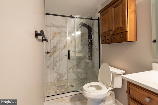 bathroom with vanity, toilet, and a shower with door