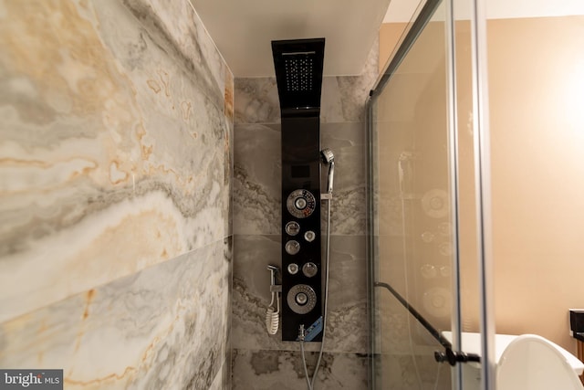 interior space featuring a shower with door