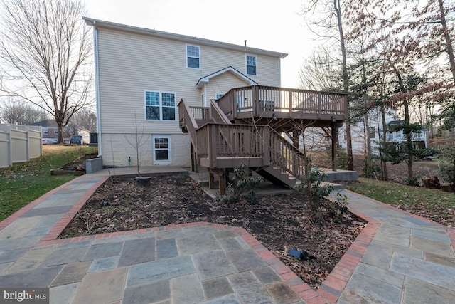 rear view of property with a deck and a patio area