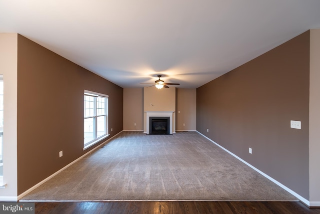 unfurnished living room with hardwood / wood-style flooring and ceiling fan