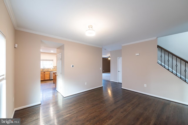 unfurnished room with crown molding, dark wood-type flooring, and ceiling fan