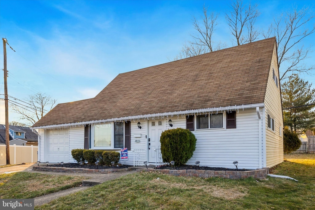 new england style home with a front lawn and a garage