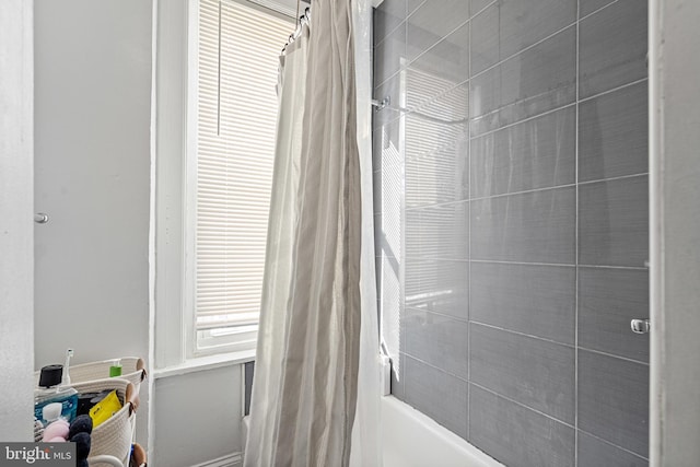 bathroom with shower / bath combo with shower curtain