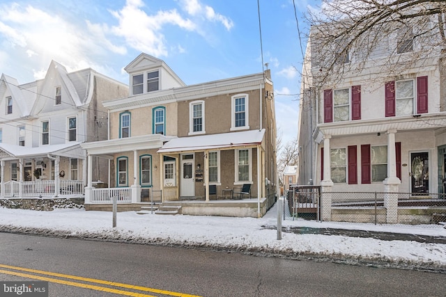 townhome / multi-family property featuring a porch