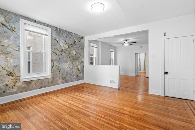 unfurnished room with ceiling fan and light hardwood / wood-style flooring