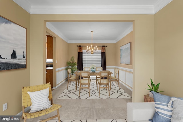 99 Trumpeter Swan Way, Magnolia, DE 19962 - dining area with a chandelier, crown molding, a wainscoted wall, and a decorative wall