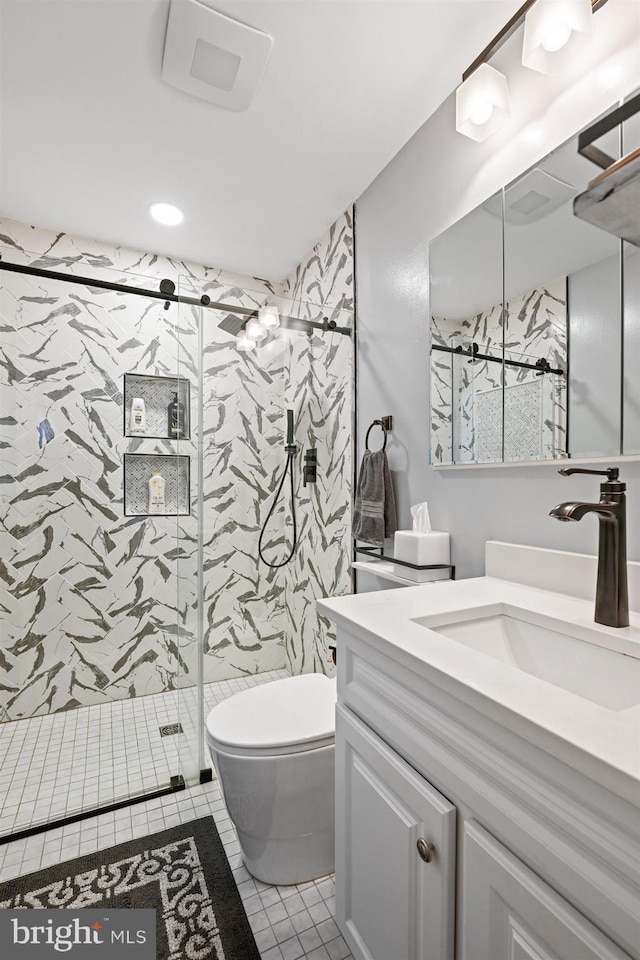 full bathroom featuring toilet, a stall shower, tile patterned flooring, and vanity