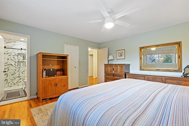 bedroom featuring light wood-type flooring, ceiling fan, and connected bathroom