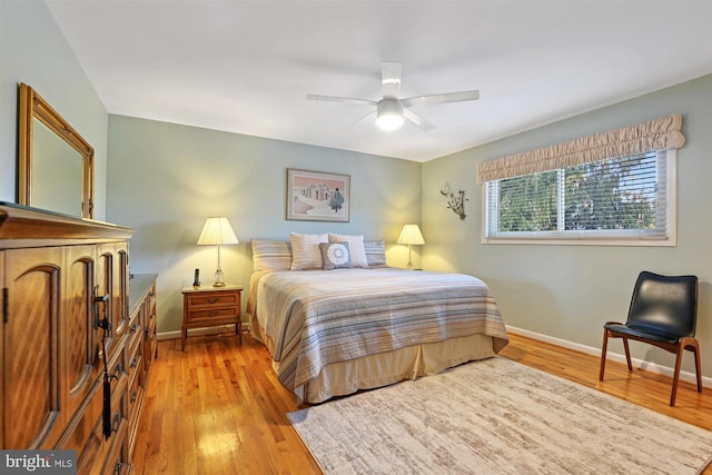 bedroom featuring light wood finished floors, ceiling fan, and baseboards