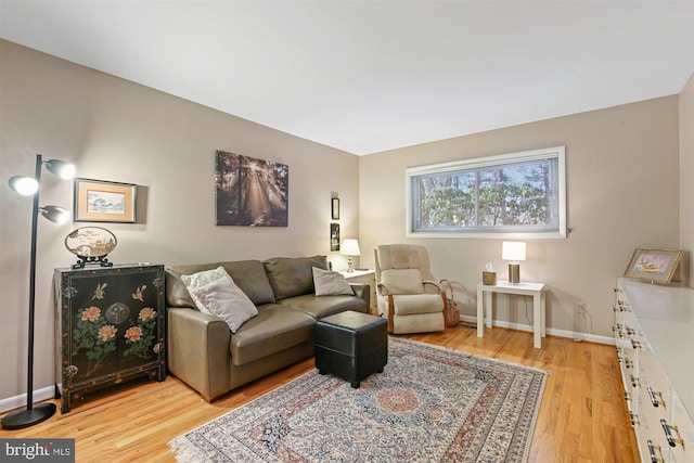 living room with light wood-type flooring and baseboards