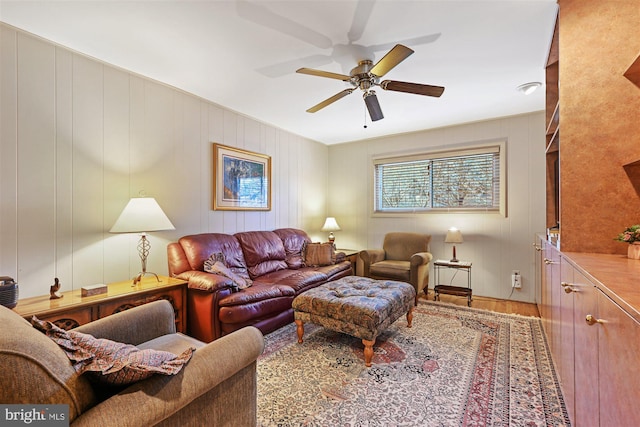 living area featuring ceiling fan and wood finished floors