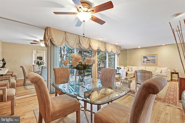 dining room featuring light wood-type flooring, baseboards, and recessed lighting