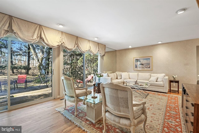 living room with light wood-type flooring and recessed lighting