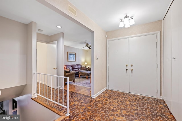 entryway featuring visible vents, ceiling fan, and baseboards