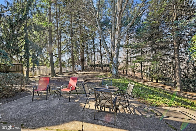 view of patio / terrace featuring outdoor dining space and fence