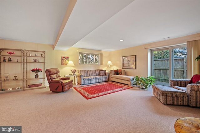 living room featuring carpet and beam ceiling