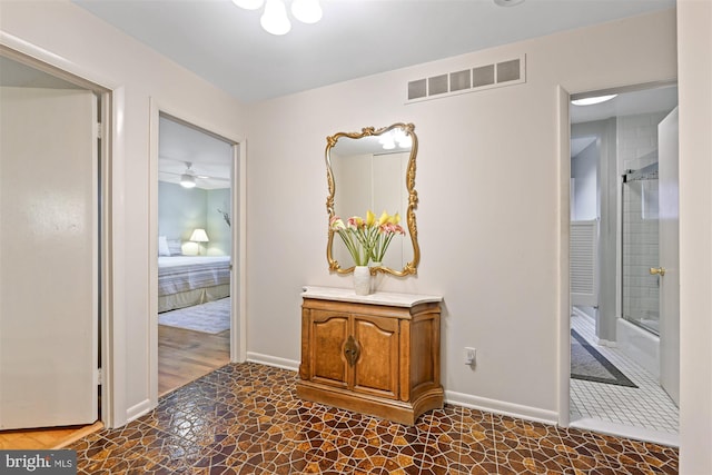 hallway with visible vents and baseboards