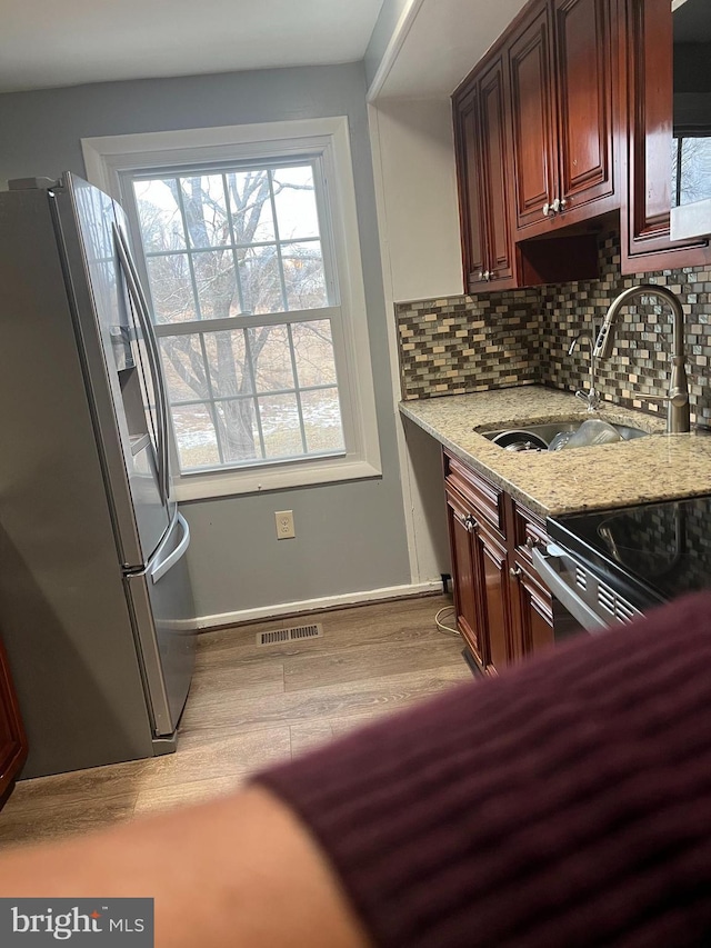 9429 Fairhaven Ave, Upper Marlboro, MD 20772 - kitchen featuring sink, backsplash, light hardwood / wood-style floors, stainless steel fridge with ice dispenser, and light stone countertops