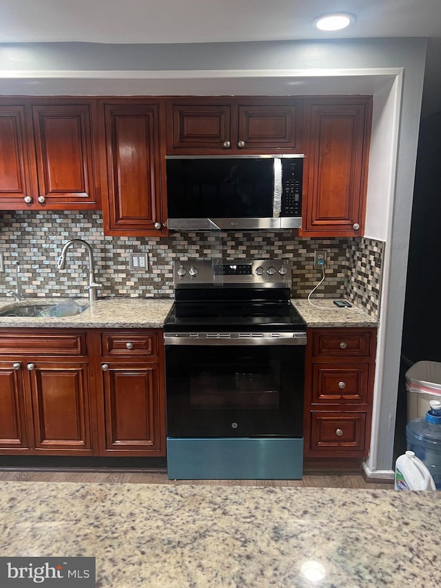 9429 Fairhaven Ave, Upper Marlboro, MD 20772 - kitchen with tasteful backsplash, stainless steel electric range oven, light stone countertops, and sink