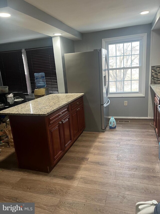 9429 Fairhaven Ave, Upper Marlboro, MD 20772 - kitchen featuring stainless steel refrigerator with ice dispenser, light wood-type flooring, and light stone counters