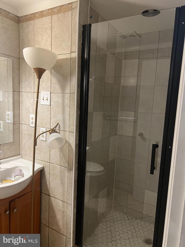 9429 Fairhaven Ave, Upper Marlboro, MD 20772 - bathroom featuring a shower with door, vanity, and tile walls