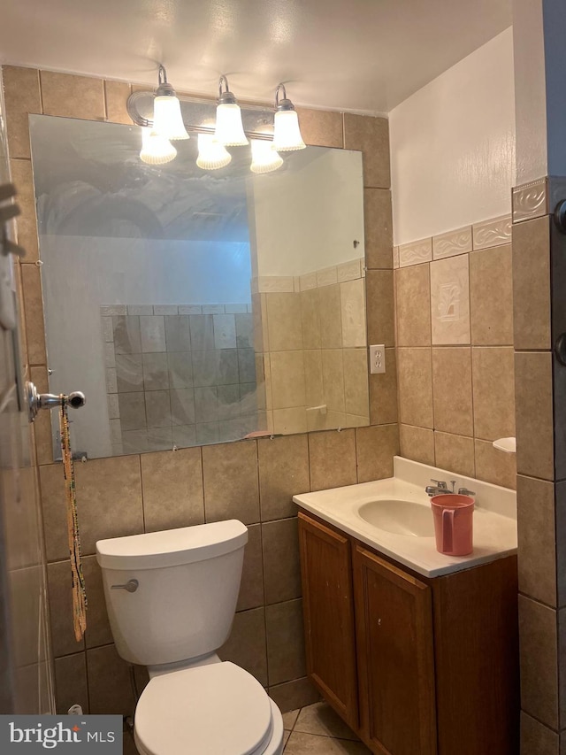 9429 Fairhaven Ave, Upper Marlboro, MD 20772 - bathroom with tile patterned floors, vanity, toilet, and tile walls