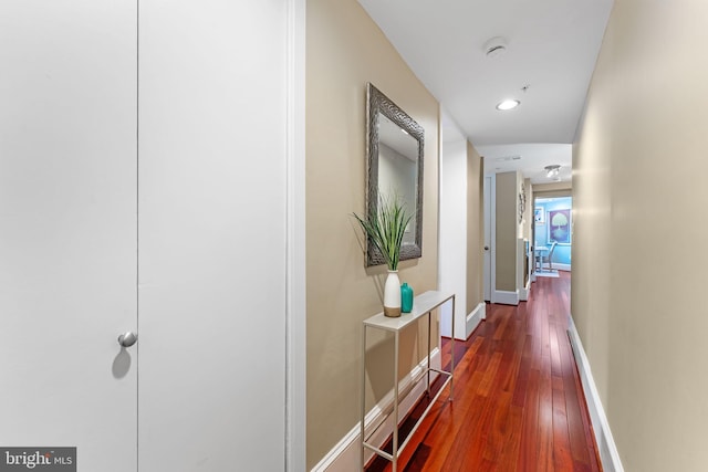 hallway with dark hardwood / wood-style floors