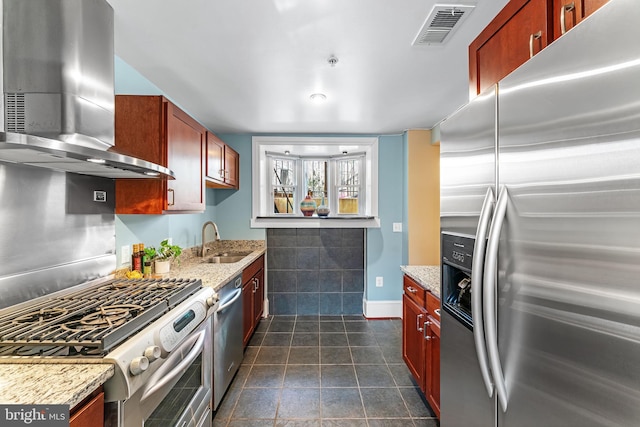 kitchen with light stone countertops, sink, appliances with stainless steel finishes, and island range hood