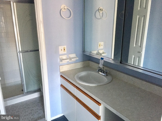 bathroom with vanity, tile patterned floors, and an enclosed shower