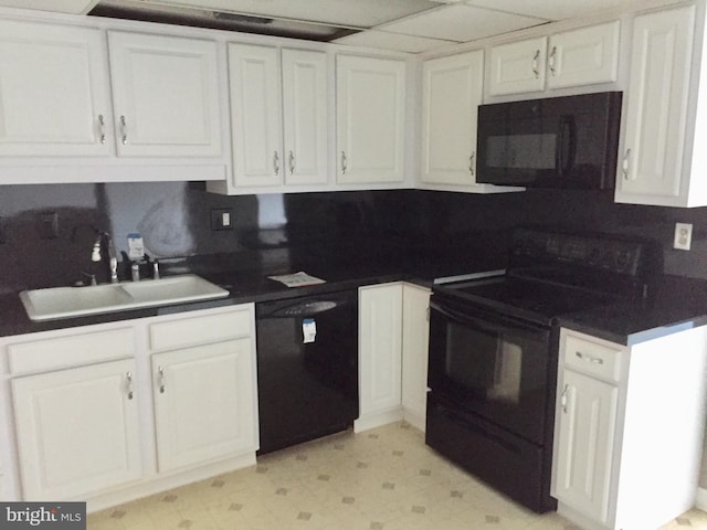 kitchen with sink, white cabinetry, and black appliances